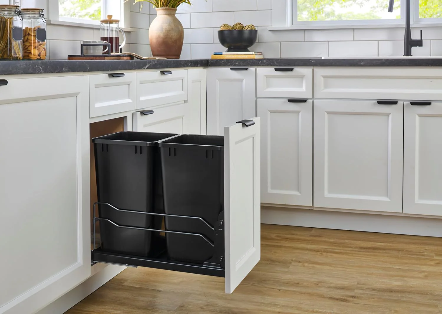 A double pull-out trash can suitable for the bottom of kitchen cabinets. with a capacity of 35 ounces (approximately 0.875 gallons). equipped with a gentle closing sliding mechanism. and in the color of Orison Gray.